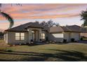 Single-story home with attractive landscaping and two-car garage at 36729 Alaqua Ct, Eustis, FL 32736