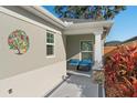 Inviting side entrance with seating area and colorful landscaping at 5569 Bougainvillea Ave, The Villages, FL 32163