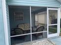Relaxing screened porch with wicker furniture, perfect for enjoying the outdoors at 718 Villita Ln, Lady Lake, FL 32159
