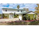 Beautifully designed two-story home features white and green exterior with a spacious driveway at 13131 Mountain Vw, Clermont, FL 34715