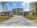 Desirable home features a paver driveway, three-car garage, and meticulously maintained lawn at 16937 Crete Way, Bella Collina, FL 34756