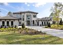 Beautiful two-story home showcases manicured landscaping and a spacious paver driveway at 16937 Crete Way, Bella Collina, FL 34756