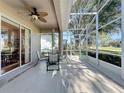 Screened patio with table and chairs, overlooking a golf course at 2211 Stonebridge Way, Clermont, FL 34711