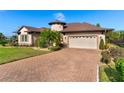 Brick paved driveway leading to a two-car garage at 38728 Oak Place Ct, Lady Lake, FL 32159