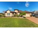 Beautiful home with architectural details and manicured lawn at 38728 Oak Place Ct, Lady Lake, FL 32159