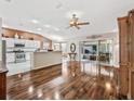 Open kitchen boasting hardwood floors, ample counter space, and a breakfast bar at 1315 Greenville Way, The Villages, FL 32162