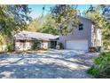 Two-story house with a large driveway, attached garage, and landscaping at 1415 E 9Th Ave, Mount Dora, FL 32757