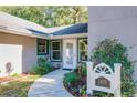 Welcoming front entrance with landscaping and a house number sign at 1415 E 9Th Ave, Mount Dora, FL 32757