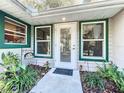 Charming front entrance with lush landscaping and a decorative sign at 1415 E 9Th Ave, Mount Dora, FL 32757