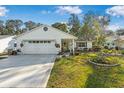 Charming single-story home featuring a well-manicured lawn and attached two car garage at 1214 Loch Rannoch Ct, Leesburg, FL 34788