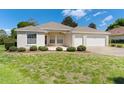 Charming home with well-manicured front lawn and garden at 5009 Harbor Hts, Lady Lake, FL 32159
