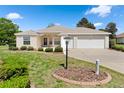 Well-kept home showcasing manicured front yard with beautiful landscaping at 5009 Harbor Hts, Lady Lake, FL 32159