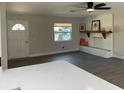 Open-concept living area boasts modern gray flooring and a built-in bench with floating shelf at 11 The Crescent, Minneola, FL 34715