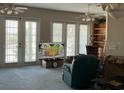 Open living area with French doors, cozy seating, and built-in shelving at 1063 Mesa Verde Ct, Clermont, FL 34711