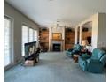 Inviting living room with a fireplace, shelving, and abundant natural light at 1063 Mesa Verde Ct, Clermont, FL 34711