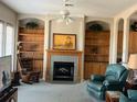 Comfortable living room boasts a fireplace, built-in shelves, and cozy seating at 1063 Mesa Verde Ct, Clermont, FL 34711
