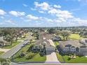 Aerial view of a single-Gathering house and surrounding neighborhood at 1427 Fortaleza Dr, The Villages, FL 32162