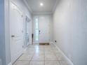 Bright entryway with tile flooring, white walls, and neutral decor at 2150 White Dahlia Dr, Apopka, FL 32712