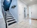 Modern staircase with black and white steps and metal railing at 2150 White Dahlia Dr, Apopka, FL 32712