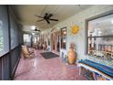 Relaxing screened porch with rocking chairs, tile floor, and access to the backyard at 3140 Se 23Rd Pl, Sumterville, FL 33585