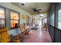 Inviting screened porch with rocking chairs and access to the front entrance at 3140 Se 23Rd Pl, Sumterville, FL 33585