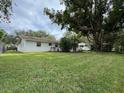 Spacious backyard with a large tree and grassy area at 530 Mar Nan Mar Place, Clermont, FL 34711