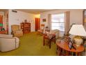 Cozy living room featuring vintage furniture and green carpet at 530 Mar Nan Mar Place, Clermont, FL 34711