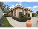 View of the house's side, showcasing its landscaping and architectural details at 9033 Saint Andrews Way, Mount Dora, FL 32757