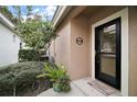 Inviting front entrance with a black door and welcoming decor at 9033 Saint Andrews Way, Mount Dora, FL 32757