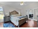 Main bedroom with king-size bed and access to office at 917 Hawk Lndg, Fruitland Park, FL 34731