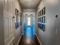 Bright entry hall with dark wood-look flooring and gallery wall at 1270 Stratton Ave, Groveland, FL 34736