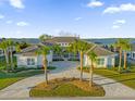 Luxury home with circular driveway and palm trees at 30303 Island Club Dr, Tavares, FL 32778