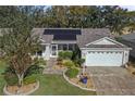 Single-story home with solar panels and landscaped yard at 3550 Auburndale Ave, The Villages, FL 32162