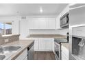 Modern kitchen with white cabinets and granite countertops at Tbd S Central Ave # Parcel C, Apopka, FL 32703