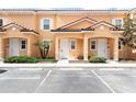 Three-unit townhome building with parking in front at 2604 Roadster Ln, Kissimmee, FL 34746