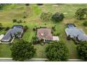 Expansive aerial view of the property, surrounded by lush landscaping and scenic views at 39539 Harbor Hills Blvd, Lady Lake, FL 32159