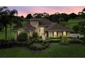 Stunning exterior elevation showcasing a meticulously landscaped front yard and inviting pathway at 39539 Harbor Hills Blvd, Lady Lake, FL 32159