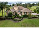Gorgeous home featuring lush landscaping, manicured lawn, and a welcoming entrance at 39539 Harbor Hills Blvd, Lady Lake, FL 32159