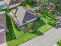 An aerial view of a single-story home showcasing the large, lush backyard, screened lanai, and nearby landscaping at 11584 Se 175Th St, Summerfield, FL 34491