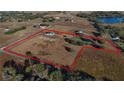 Expansive aerial view showcases the property's boundaries, house, ponds, and surrounding landscape at 2437 Bay Lake Loop, Groveland, FL 34736