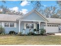 Charming light blue house with a covered porch and two-car garage at 8850 Sw 97Th St # E, Ocala, FL 34481