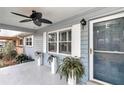 Covered porch with light blue walls, ceiling fan, and potted plants at 8850 Sw 97Th St # E, Ocala, FL 34481