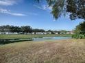 Landscaped backyard with pond and golf course view at 1710 Hilton Head Blvd, The Villages, FL 32159