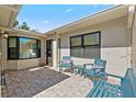 Private brick patio with comfortable seating, providing a relaxing outdoor space with ample natural light at 2247 Cypress Cove Dr # E2, Tavares, FL 32778