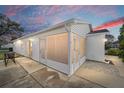 Back of house with screened patio and table setting at 2907 Barboza Dr, The Villages, FL 32162