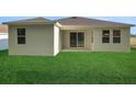 Enjoy the spacious backyard with lush green grass, perfect for outdoor activities and relaxation at 2992 Supermarine Rd, Tavares, FL 32778