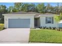 Charming one-story home boasts a two-car garage and well-manicured lawn, creating an inviting curb appeal at 2992 Supermarine Rd, Tavares, FL 32778