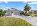 Attractive curb appeal with a two-car garage and manicured lawn at 3248 Killington Loop, The Villages, FL 32163