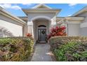 Inviting front entry with a walkway and nicely landscaped area at 3248 Killington Loop, The Villages, FL 32163