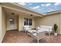 Relaxing patio with seating area and view of the backyard at 5312 Galley Way, Oxford, FL 34484